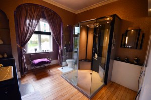 Beautiful luxury bathroom with a striking feature shower area using a made to measure shower tray in grey sparkle