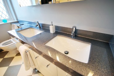 Silver vanity top with 2 white basins.